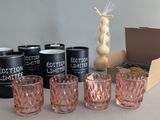 six glasses and a can of cotton gin on the table
