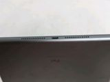 the back of a black laptop computer sitting on top of a white table