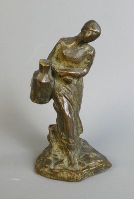 bronze figurine of a woman holding a basket of flowers