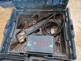 a tool in a blue case with a cord in it