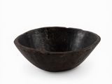 an old wooden bowl on a white surface with a white background