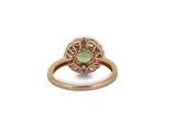 a close up of a gold ring with a green and pink stone