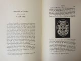 an open book with a picture of a coat of arms on it