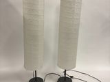 pair of white paper lamps with black bases and black bases