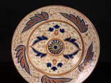 an image of a decorative plate with blue and orange designs