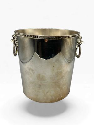 an antique silver plated ice bucket with handles on a white background