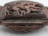 an antique wooden box with carvings of birds and flowers on it