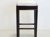 an image of a black and white stool with a white seat