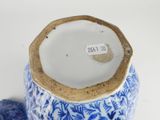 a blue and white vase with a tag on it