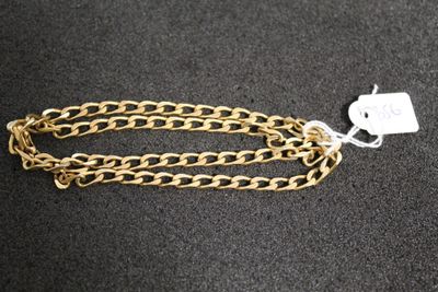 a close up of a gold chain with a tag on it