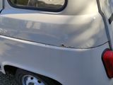 a small white van parked in a parking lot