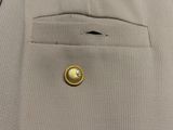 a close up of a button in the pocket of a suit
