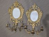 two mirrors and a candle holder on the wall