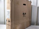 a cardboard box sitting on a table with a face drawn on it