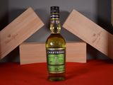 a bottle of whisky sitting on a table next to wooden blocks