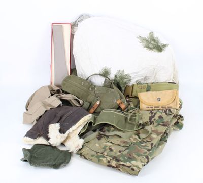 a bag full of military items on a white background