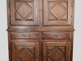 an old wooden cabinet with two doors and two drawers