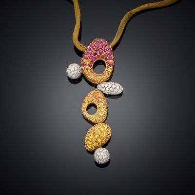 a gold necklace with pink and white stones on a black background