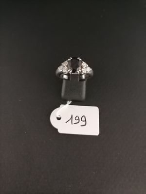 a close up of a pair of earrings sitting on top of a table