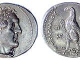 a close up of a coin with a bird on it