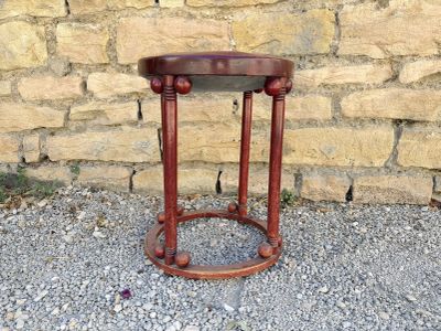 a small table that is sitting in front of a brick wall