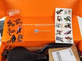 an orange box with a motorcycle in it and a sticker on the inside of it