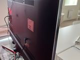 a tv that is sitting on top of a glass table