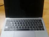 an apple macbook pro laptop computer sitting on top of a wooden desk