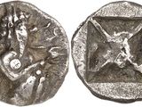 a close up of a silver coin with a woman on it