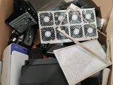 a cardboard box filled with electronics and other items