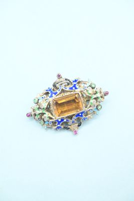 an image of a brooch with a citrine and multicolored stones
