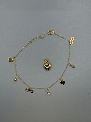 a gold bracelet with charms and a heart on it