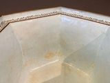 a white bowl with a gold trim around it