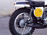 a white and yellow motorcycle parked in a parking lot