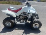 a white quad bike parked on the side of the road