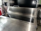 a large stainless steel grill in the middle of a kitchen