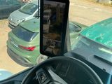 dashboard view of a car with a cell phone in the driver ' s seat