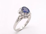 a blue sapphire and diamond ring on a white background