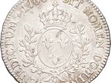 a silver coin with a crown on top of it