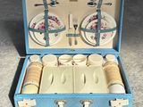 a blue suitcase with a set of dishes and utensils in it
