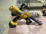 a yellow and black power drill on a wooden table