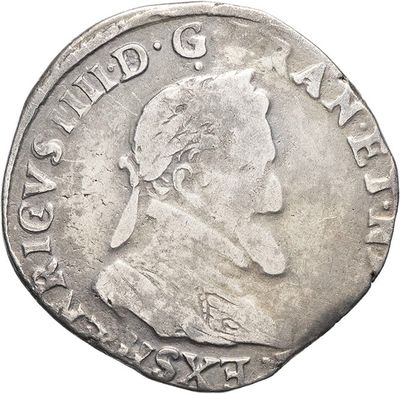 an old silver coin with a man ' s face on it
