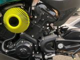 a close up of a motorcycle engine with a yellow air filter