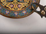 a gold plate with a blue and red design on it