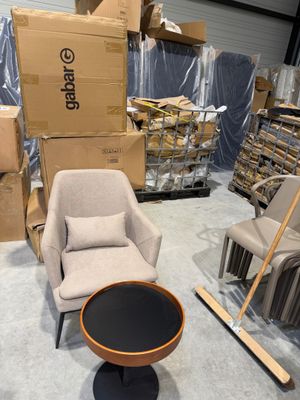 une chaise et une table dans une pièce remplie de cartons