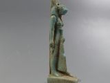 une statue égyptienne antique représentant une femme tenant un enfant dans ses bras