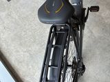 a bicycle with a basket attached to the back of it