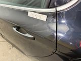 a car that has a sticker on the side of it ' s door