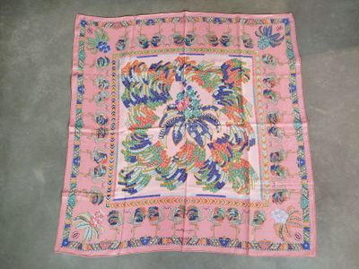 an old pink and blue paisley square scarf on a grey floor
