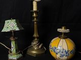 three different lamps and a lamp shade on a black background